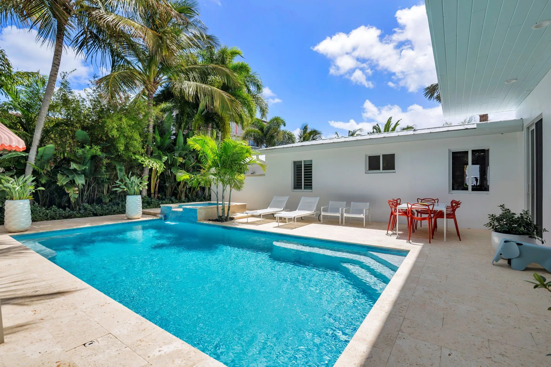 Pool and patio with palm landscaping